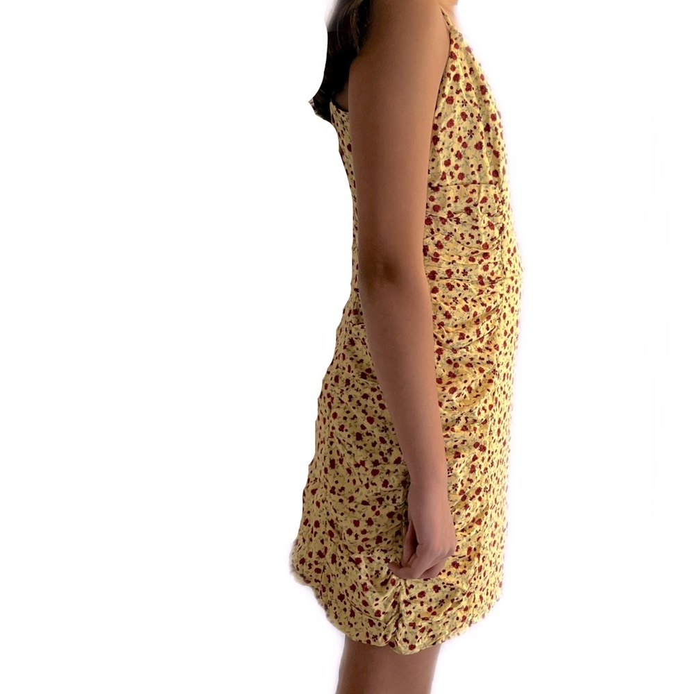 Short yellow summer dress with red flowers. The material is 100% polyester.